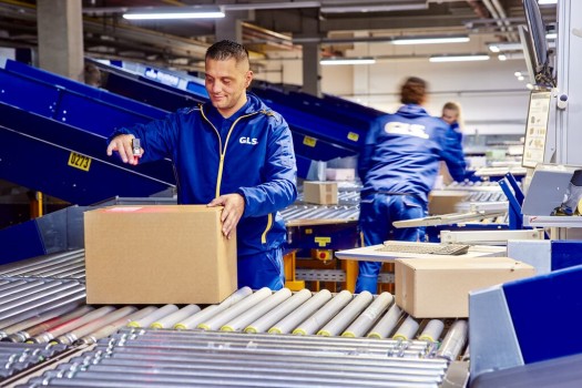 Employees smile and work together on the assembly line.